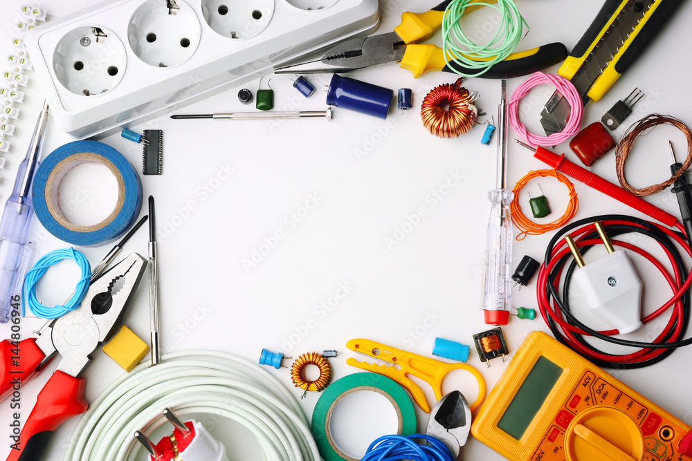 Different electrical tools on white table, top view Different electrical tools on white table, top view
