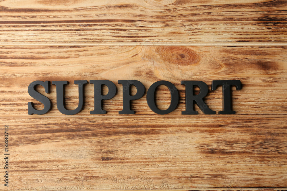 Word SUPPORT on wooden background