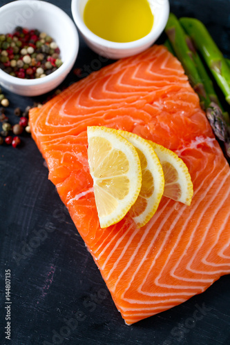 salmon fillet, lemon, asparagus and spices photo