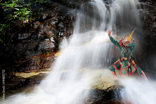 Art culture thailand dancing in masked khon hanuman Posing on the waterfall.