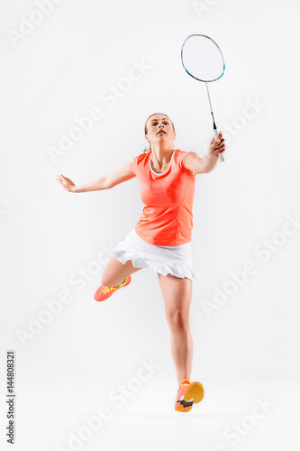 Young woman playing badminton over white background © master1305