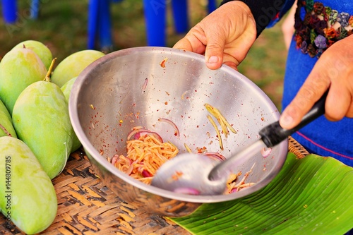Cooked raw mango is raw mango salad in a stainless steel bowl. / Mango Salad with raw Mango Salad with raw kitchen are in a stainless steel Bowl.