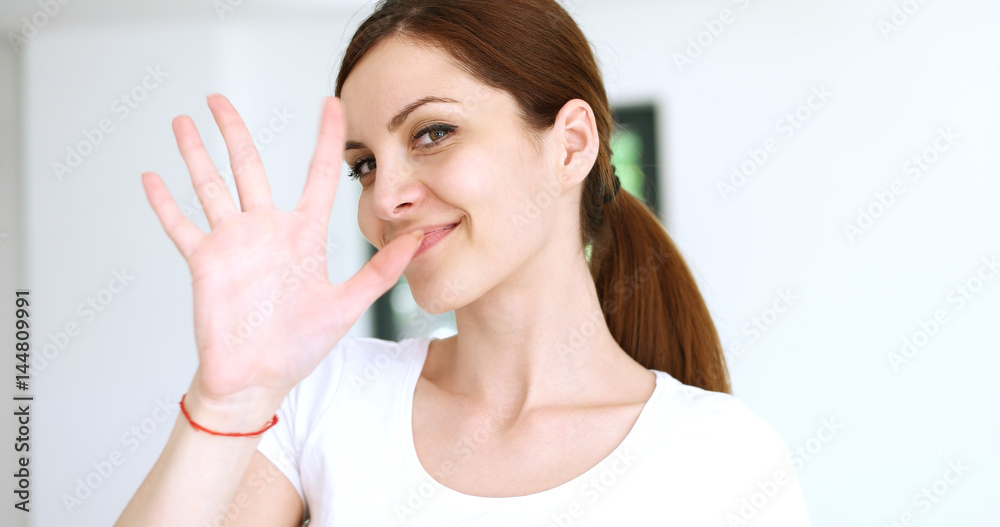 woman sending kiss to camera in modern apartment woman sending kiss to camera in modern apartment