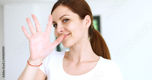 woman sending kiss to camera in modern apartment