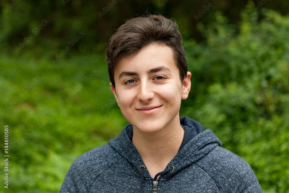 Attractive teenager guy in a park