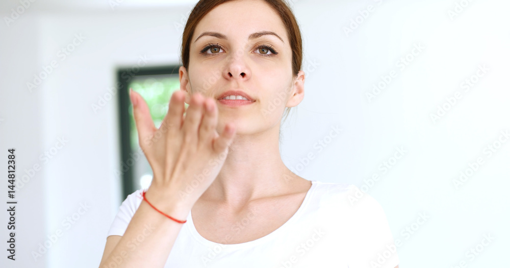 woman sending kiss to camera in modern apartment woman sending kiss to camera in modern apartment
