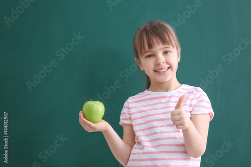 Happy schoolgirl standing w...