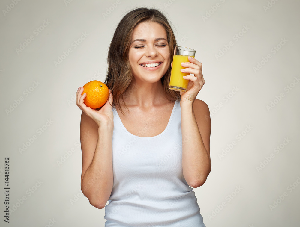 happy woman with closed eyes holds orange fruit and juice. happy woman with closed eyes holds orange fruit and juice.