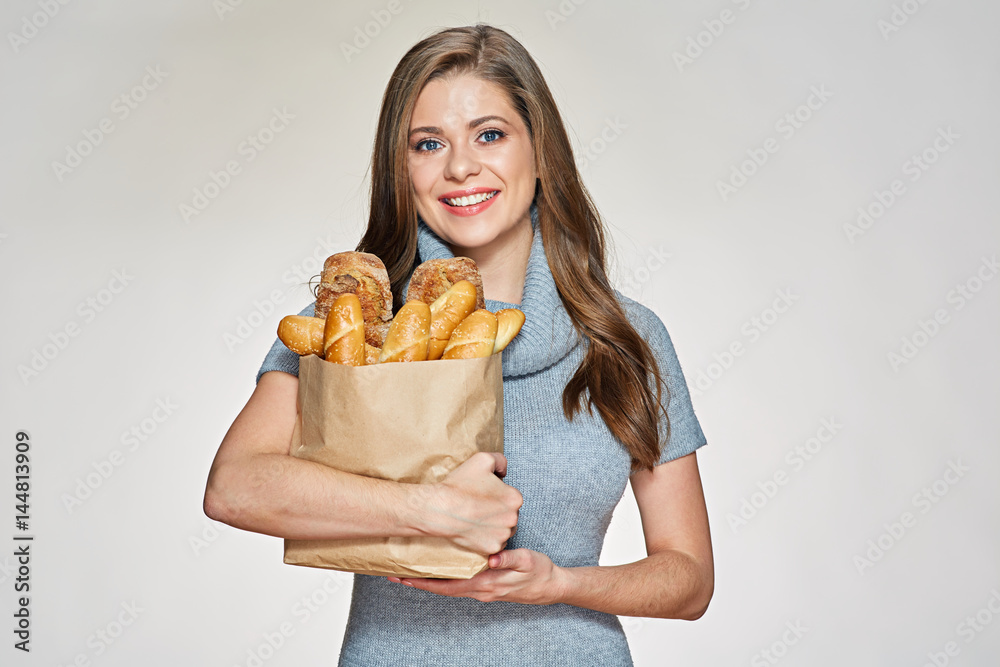 Young woman holding paper shopping with bread. Young woman holding paper shopping with bread.