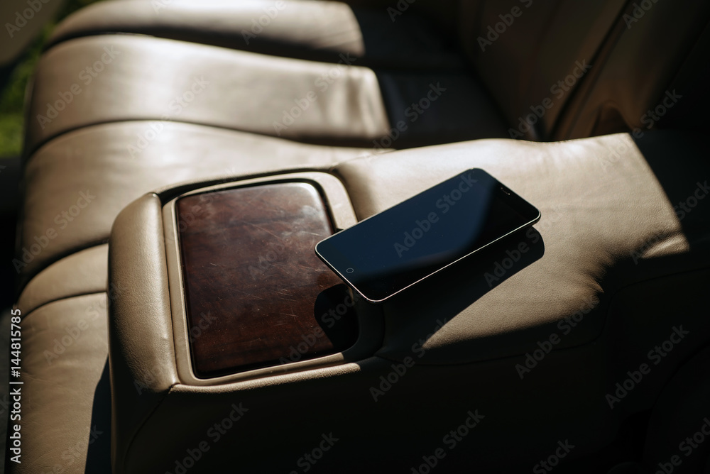 Smartphone in car at sunset