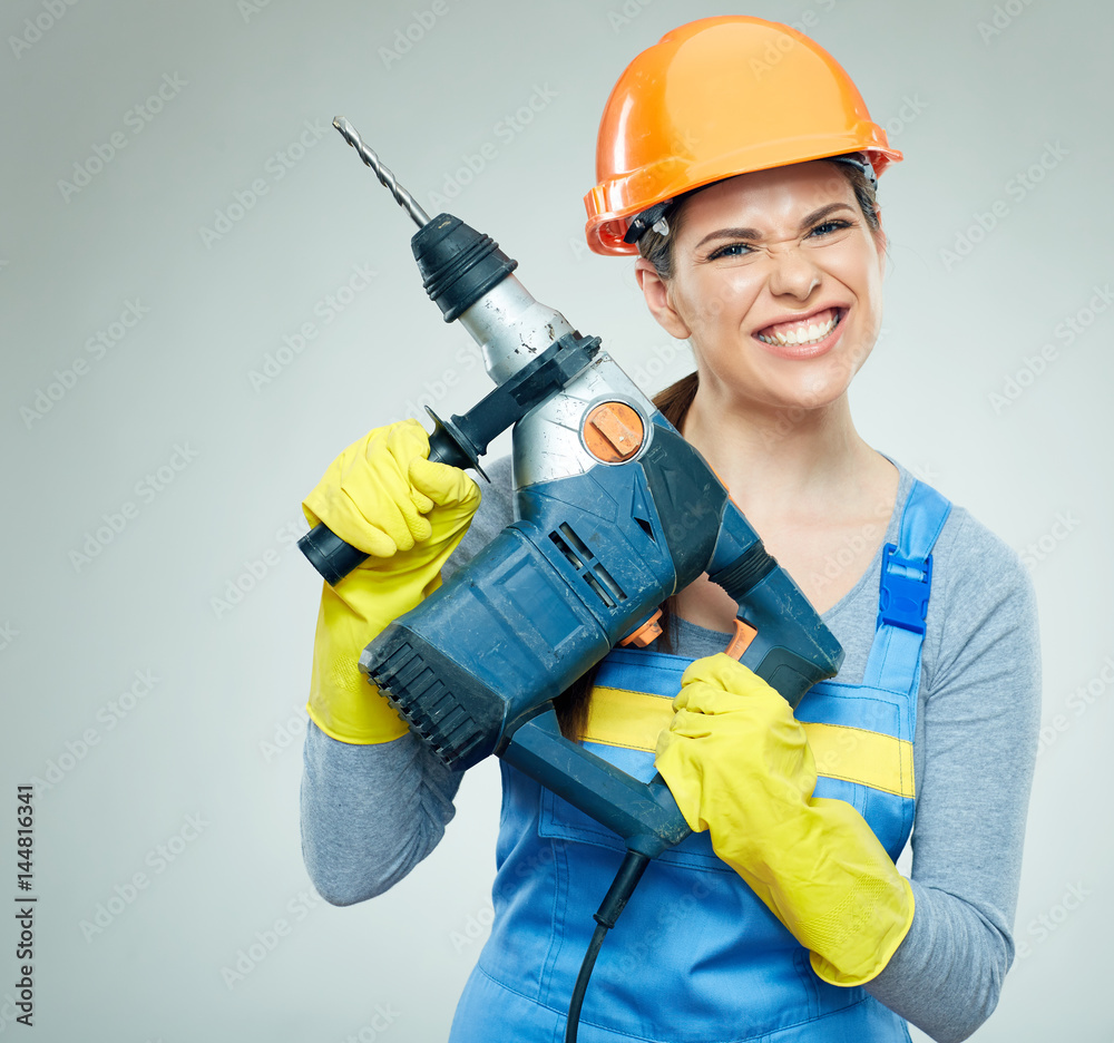 Hard work of woman builder with drill tool. Hard work of woman builder with drill tool.