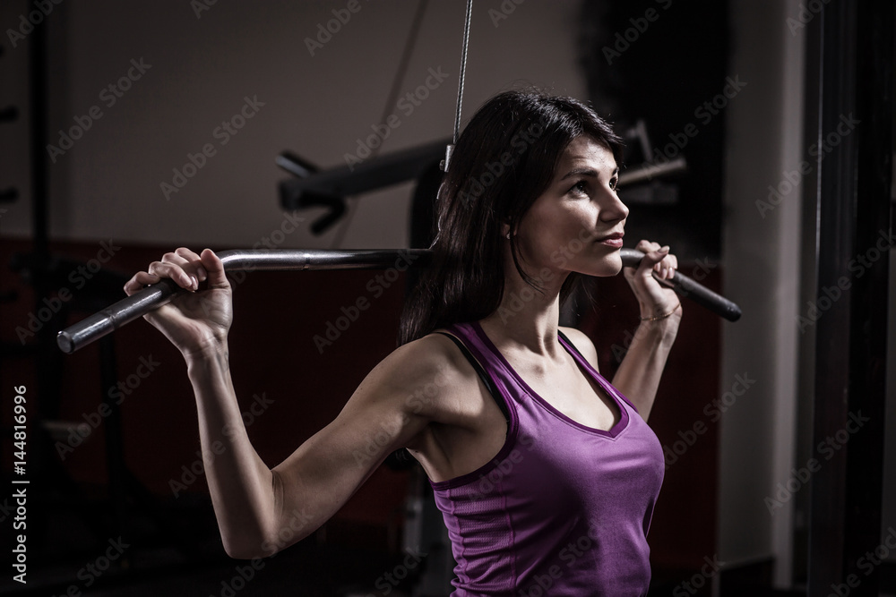 business woman doing exercise on a fitness machine in a fitness club. business woman doing exercise on a fitness machine in a fitness club.