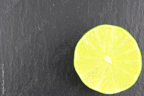 fresh lime fruit on a slate plate food background texture photo