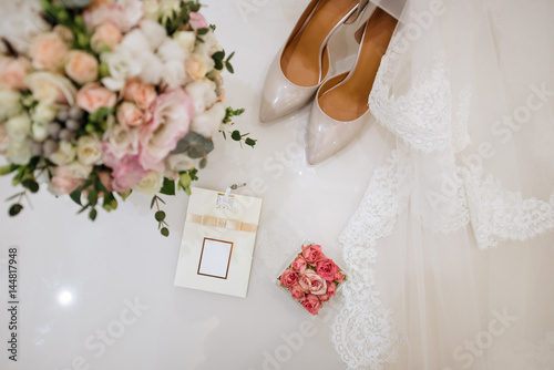 Wedding Shoes With A Small Pillow For Rings and bouquet of flowers photo
