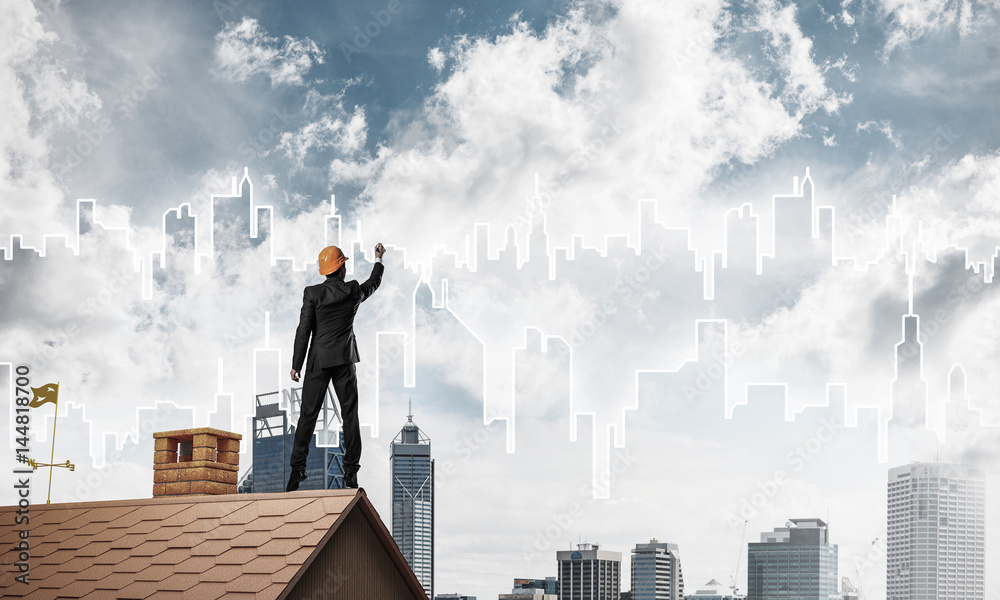 Man architect draw silhouette of modern city on blue sky. Mixed Man architect draw silhouette of modern city on blue sky. Mixed