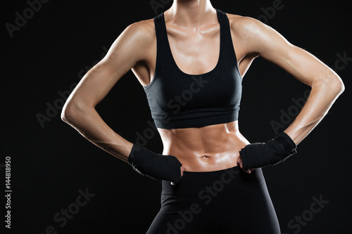 Cropped image of female fighter holding arms on hips