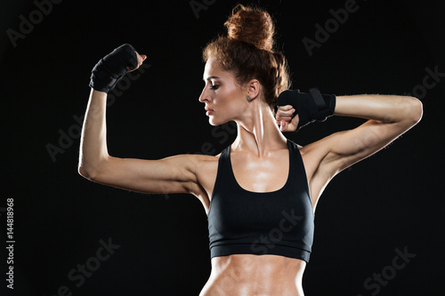 Serious female fighter showing her biceps
