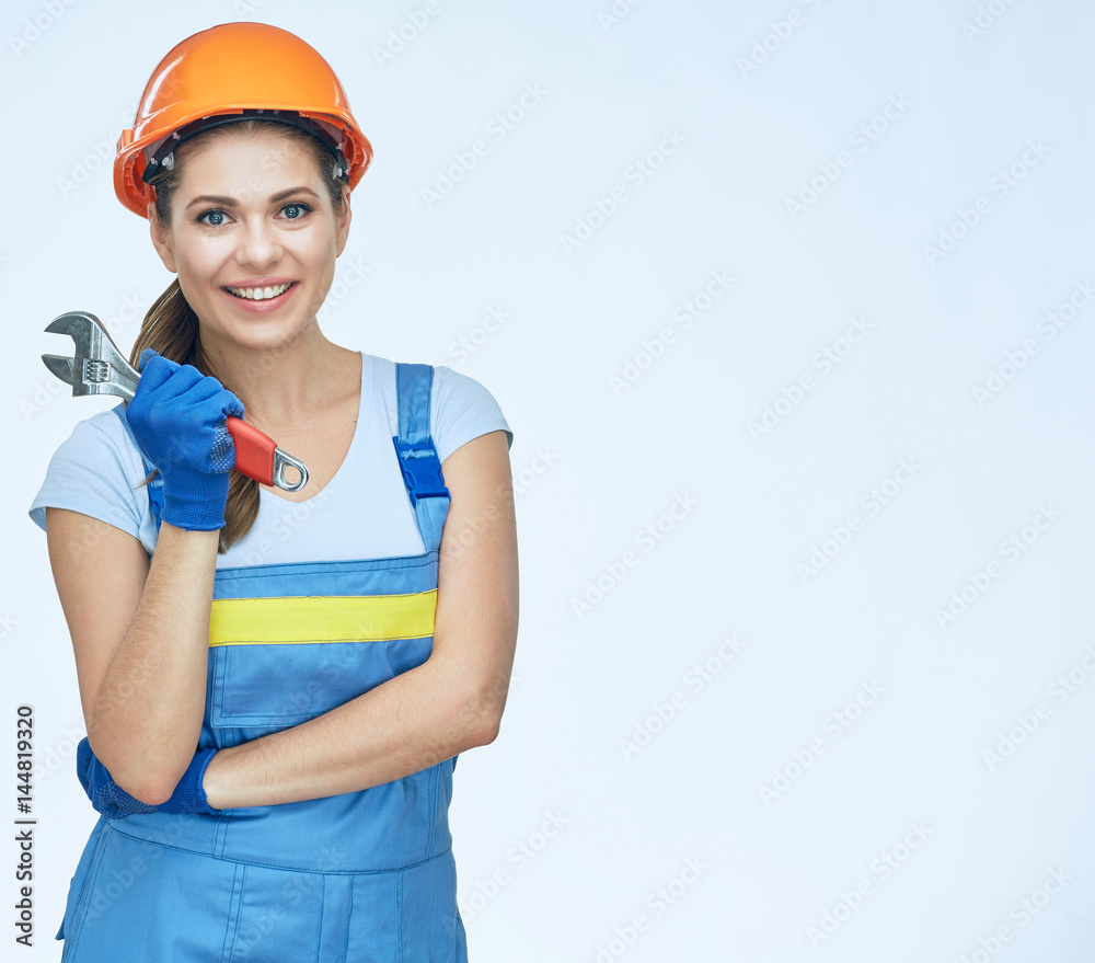 Smiling woman builder holding wrench. Smiling woman builder holding wrench.