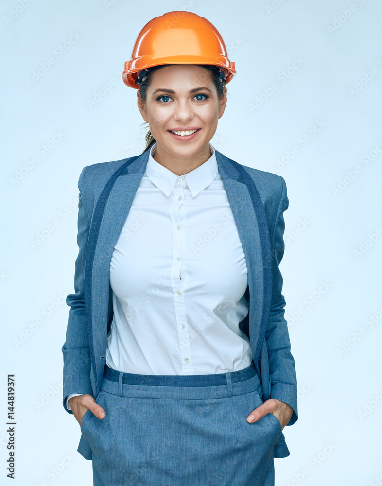 Smiling Business woman wearing builder helmet.