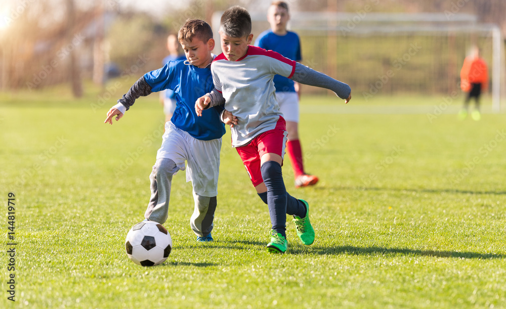 Kids soccer football - children players match on soccer field Kids soccer football - children players match on soccer field