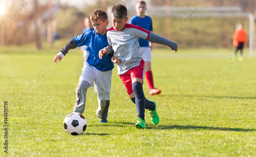 Fototapeta Naklejka Na Ścianę i Meble -  Kids soccer football - children players match on soccer field