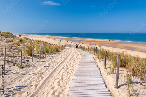 Wooden footpath in the sand dune and the beach of Lacanau, atlantic ocean, Gironde landscape, France photo