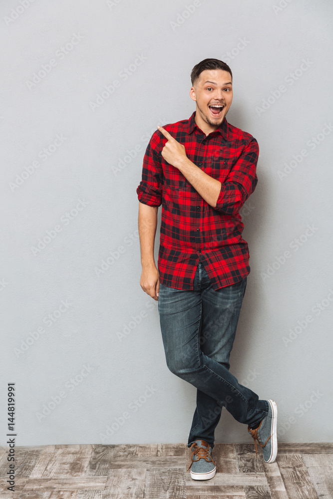 Happy young man pointing Happy young man pointing