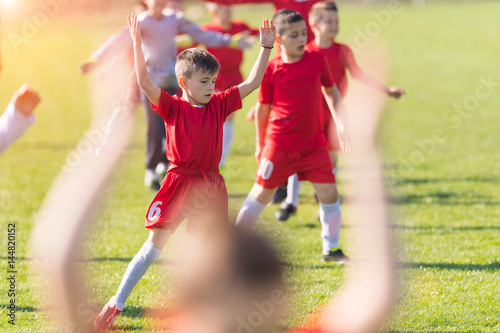 Kids soccer football - children players exercising before match on soccer field