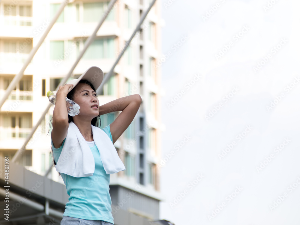 Healthy asian woman exercising  in the city.  Fitness, sport, friendship and healthy lifestyle concept.