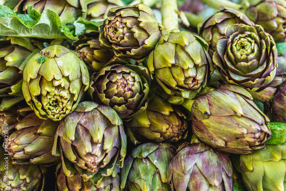 Fototapeta premium Stall with artichokes on market place of Ortygia isle, Syracuse city, Sicily Island in Italy