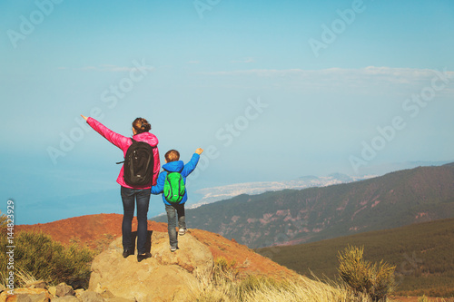 family travel- mother and son hiking in mountains