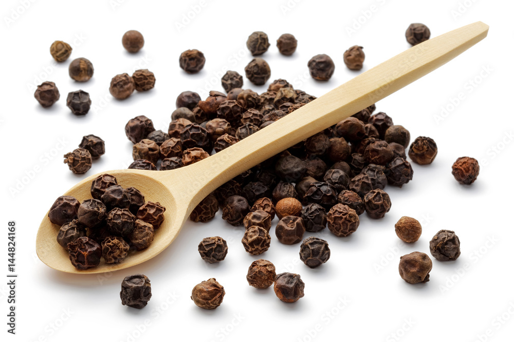 Black peppercorns in a wooden spoon Black peppercorns in a wooden spoon
