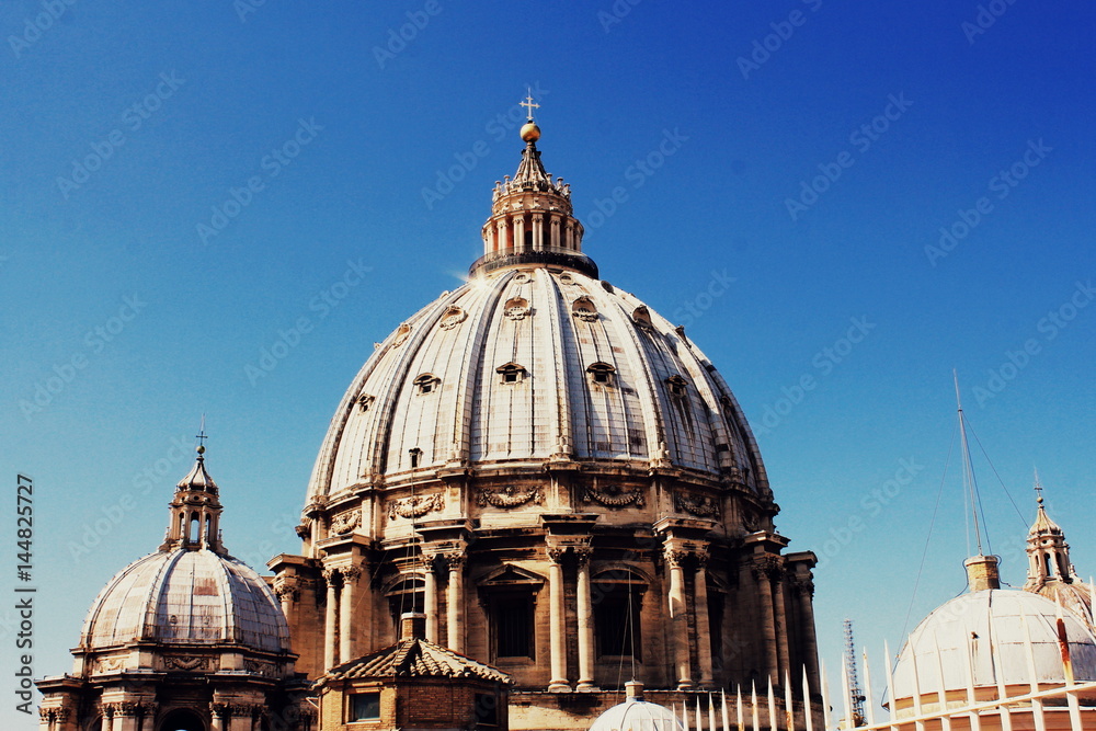 Cupola of St Peters Basilica in the Vatican, Rome, Italy against blue sky