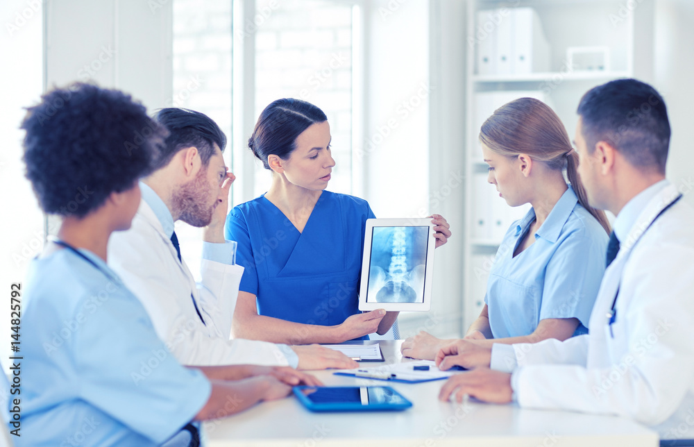 group of doctors with x-ray on tablet pc at clinic group of doctors with x-ray on tablet pc at clinic