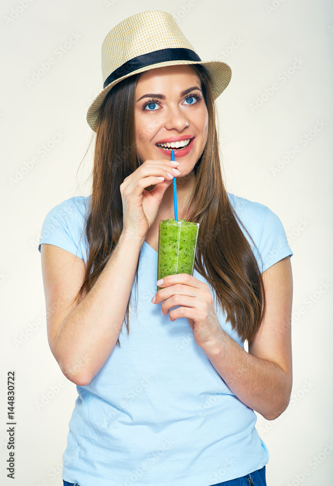 Smiling woman dressed in casual clothes and hat holding glass Smiling woman dressed in casual clothes and hat holding glass
