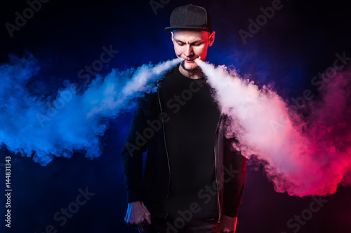 young man smoking electronic cigarette