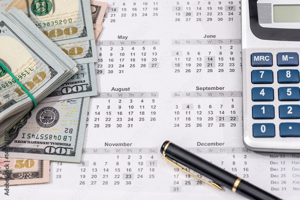 Hundred dollar bills with calendar, calculator. close up. Hundred dollar bills with calendar, calculator. close up.