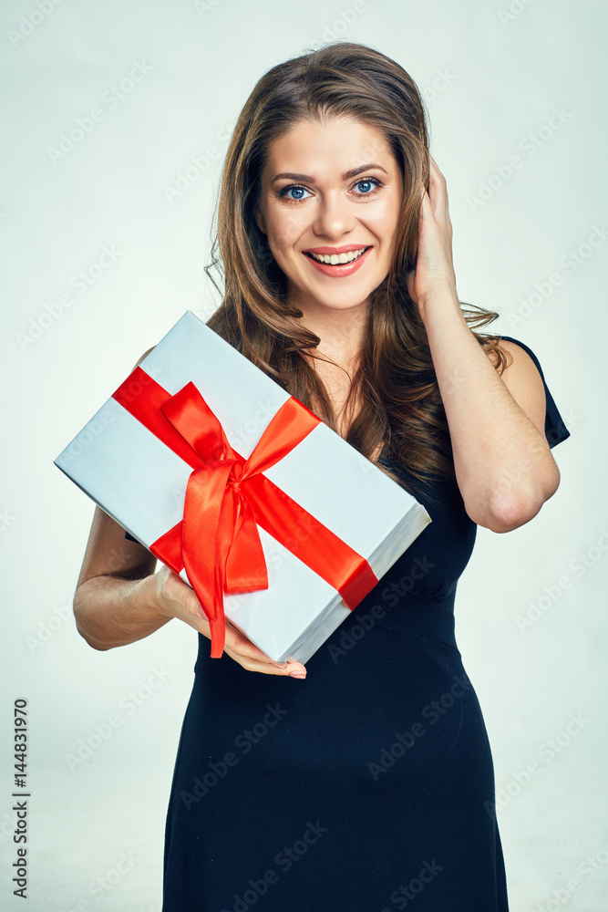 Smiling woman in black evening dress holding gift box. Smiling woman in black evening dress holding gift box.