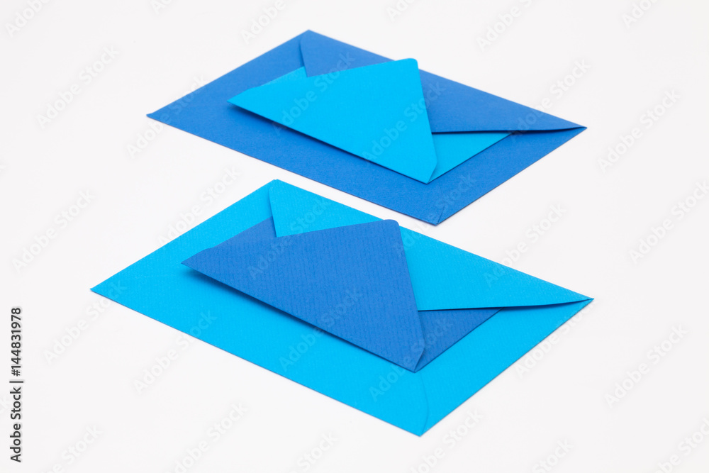 Jigsaw puzzle from big and small blue envelopes on the white table. Jigsaw puzzle from big and small blue envelopes on the white table.