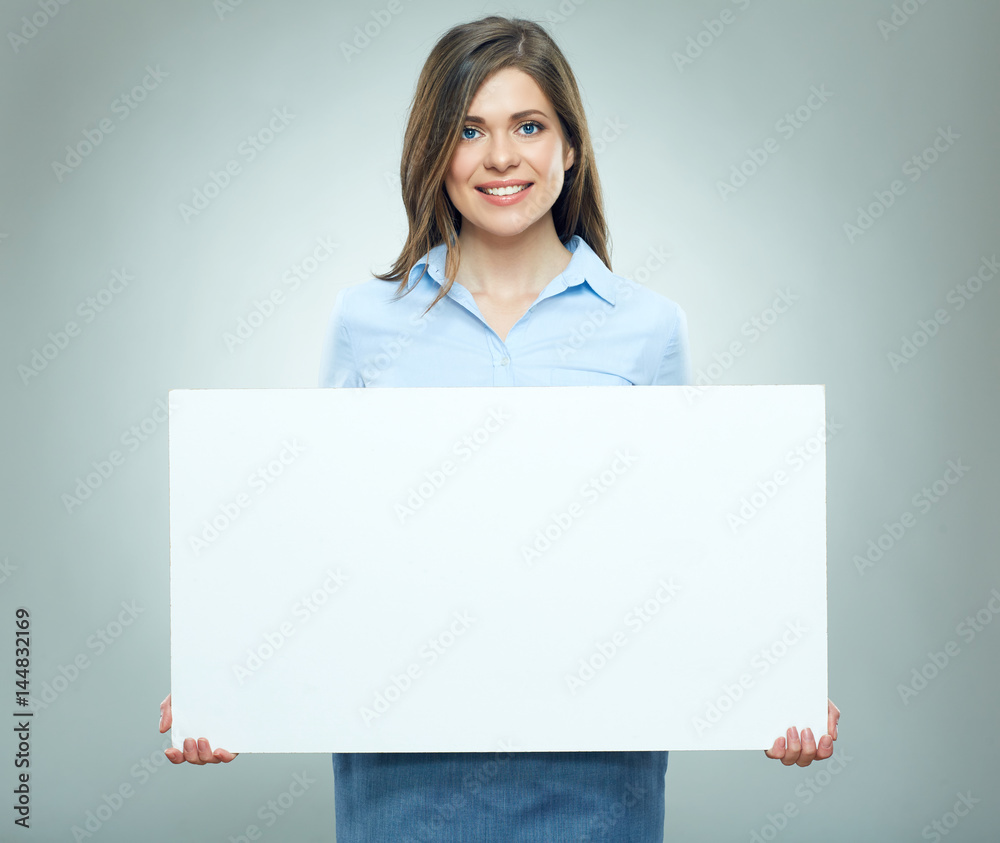 Happy young woman holding blank white banner. Happy young woman holding blank white banner.