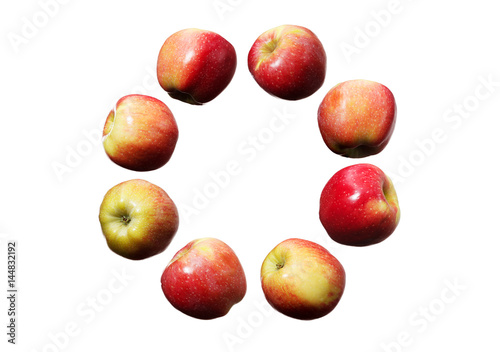Circle of falling red and yellow apples on white background isolated
