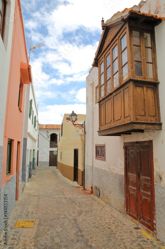 AGULO, LA GOMERA, SPAIN: Cobbled street with colorful facades and a wooden balcony