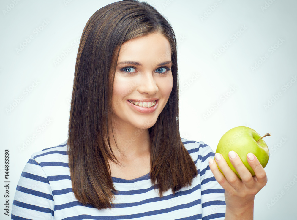Smiling woman with braces holding apple. Smiling woman with braces holding apple.