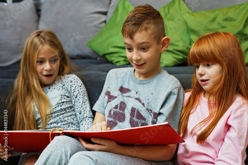 Siblings reading a book