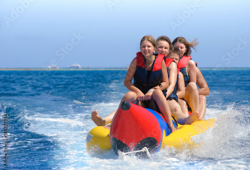 People ride on banana boat