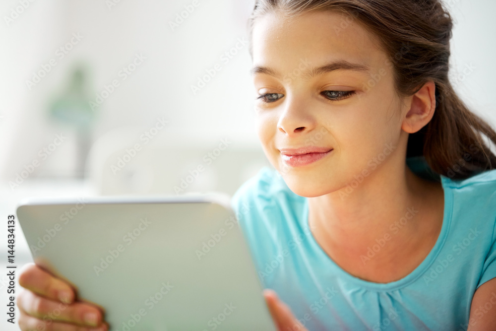 close up of smiling girl with tablet pc at home close up of smiling girl with tablet pc at home