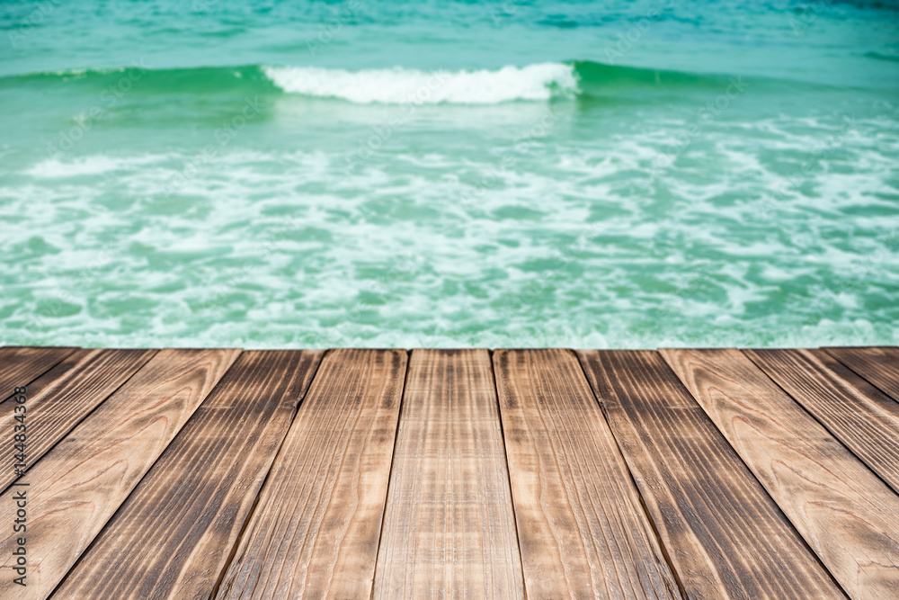Old wood table top on blurred beach background,Space available for the product Old wood table top on blurred beach background,Space available for the product