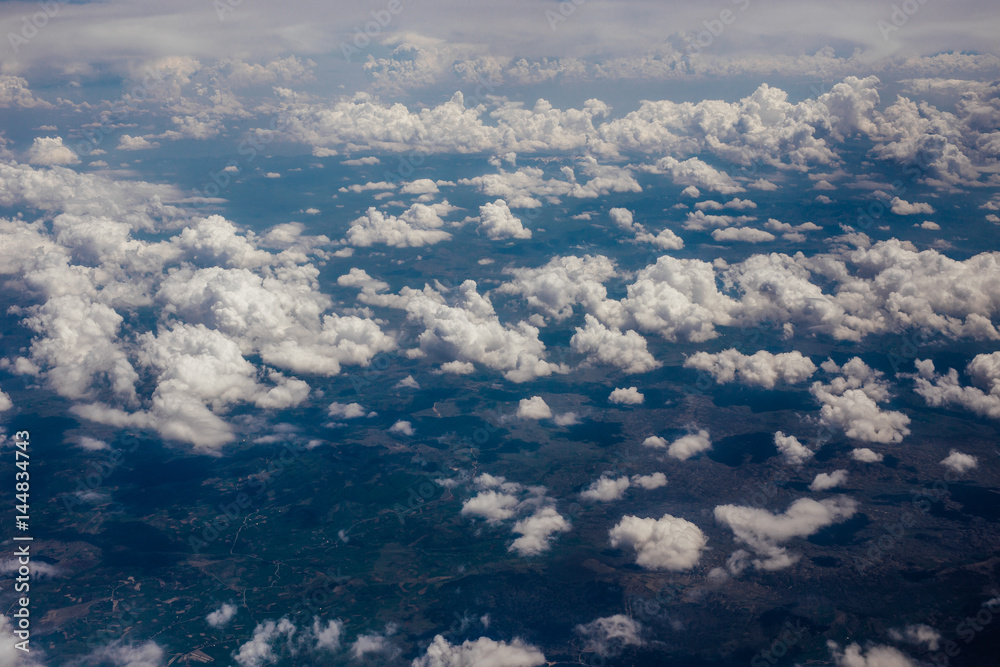 White velvet clouds in the sky, view from the airplane.