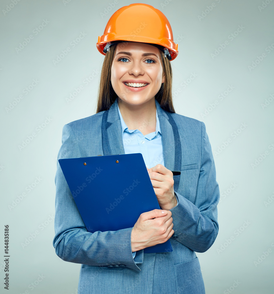Smiling businesswoman builder holding clipboard with contract Smiling businesswoman builder holding clipboard with contract