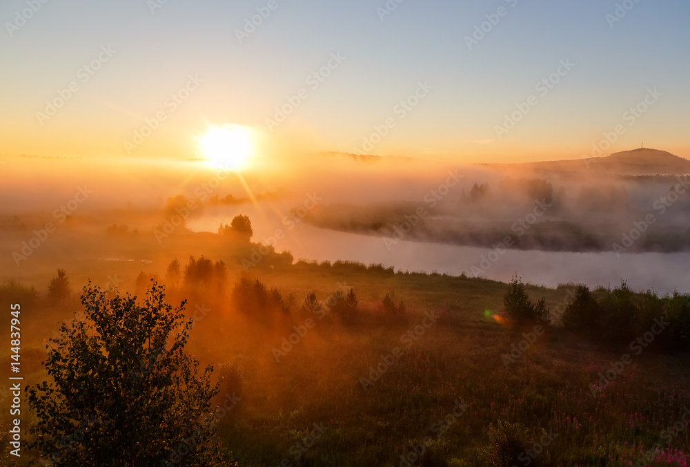 sunrise with the mist over the river and forest in Ural Russia in the summer